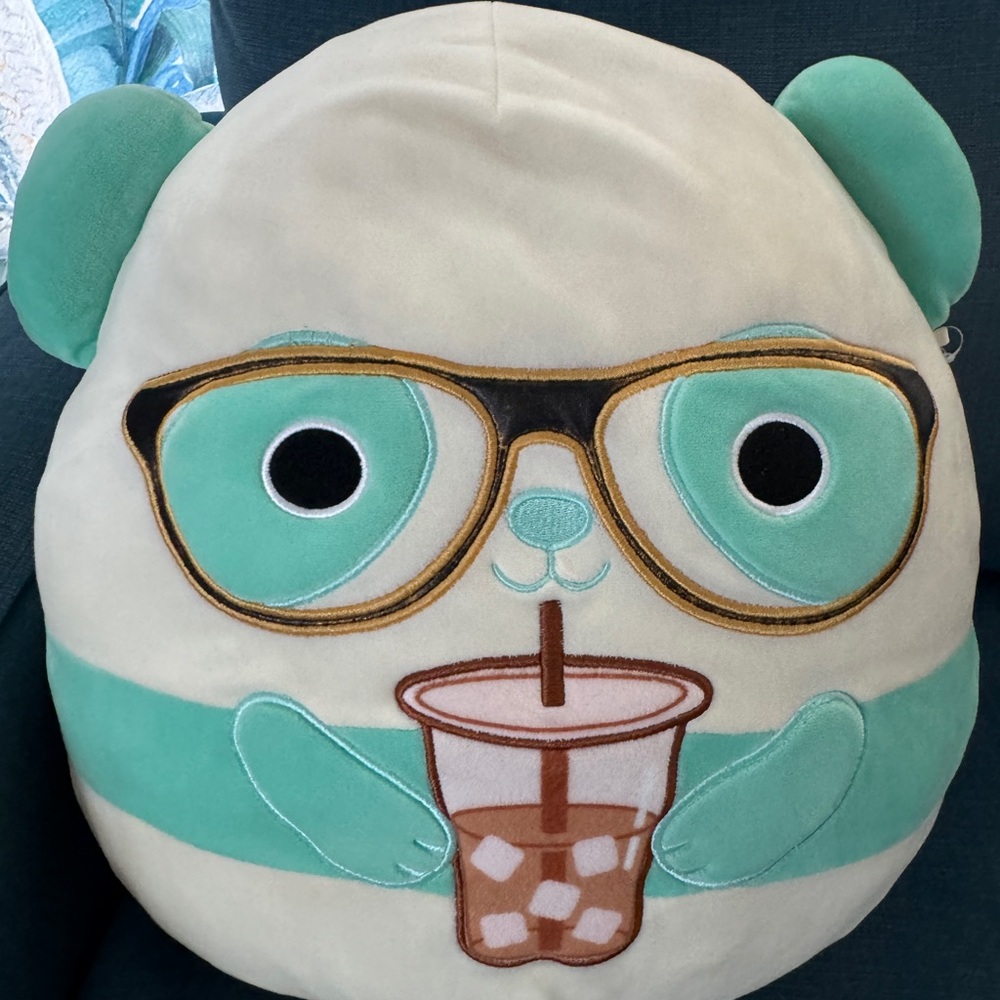 Panda Squishmallow drinking iced tea